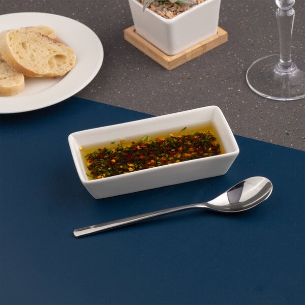 A rectangular ivory porcelain deep platter with a coupe design.