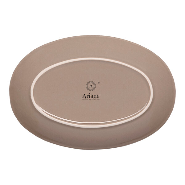 An oval beige porcelain coupe platter with the Ariane logo on the bottom.