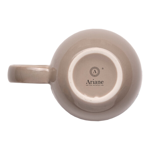 A beige porcelain mug with a handle, shown from the bottom with the Ariane brand logo visible.