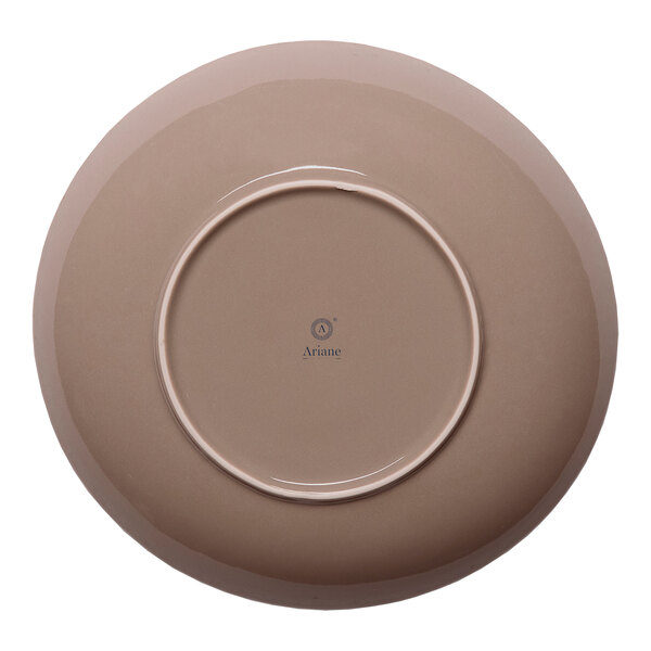 A round beige porcelain coupe deep plate viewed from the bottom.