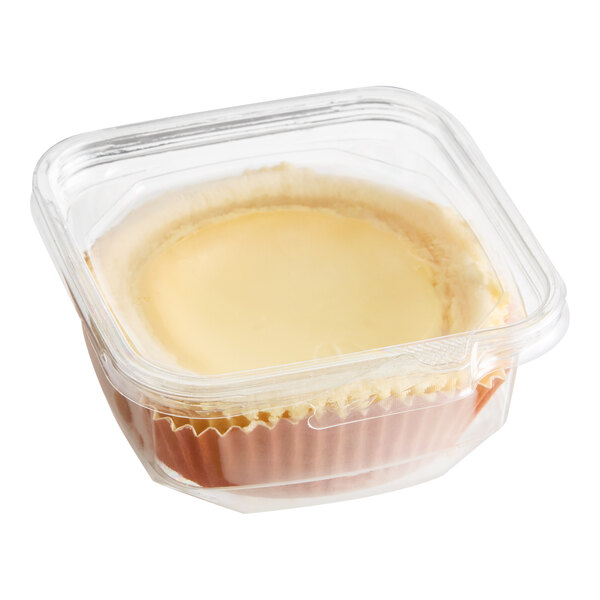 A mini cheesecake in a clear plastic container.