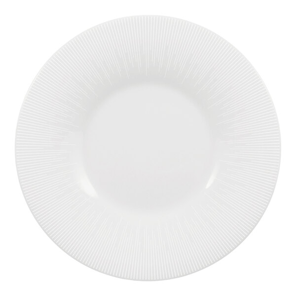 A bright white round porcelain plate with a wide rim and subtle linear pattern.