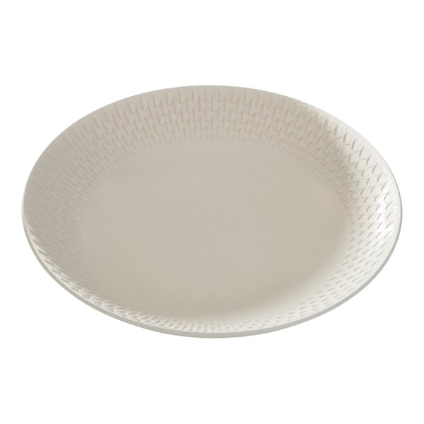 A round white deep porcelain coupe plate with a subtle textured pattern along the rim.