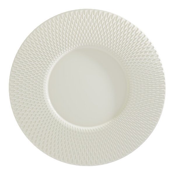 A round white porcelain plate with a wide rim featuring a textured geometric pattern.