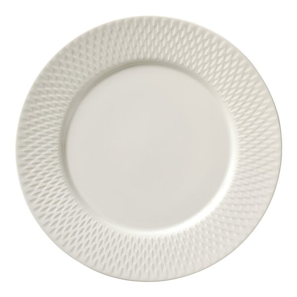 A round white porcelain plate with a wide rim featuring a textured pattern.