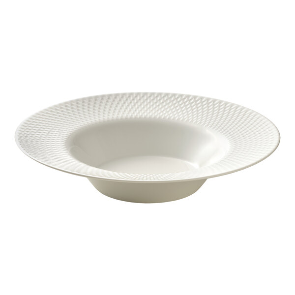 A round white wide rim deep porcelain plate with a textured pattern on the rim.