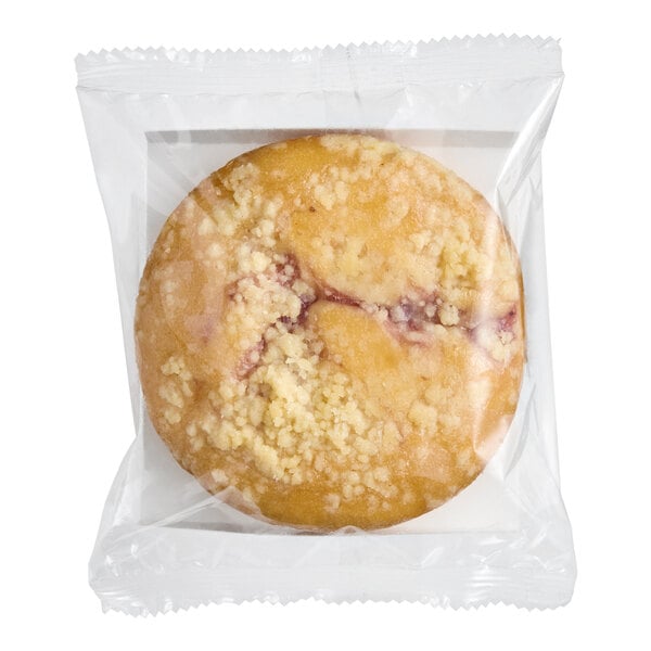 A round, individually wrapped vegan strawberry crumb cake.