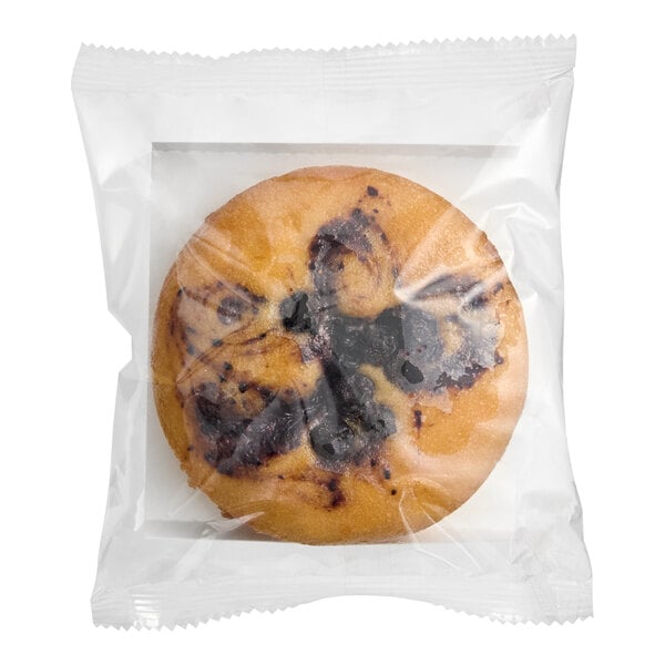 A packaged vegan blueberry cake in a clear plastic wrapper.