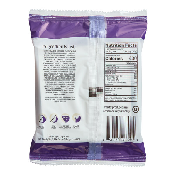 A packaged vegan tuxedo cake from Elk Village Bakery, shown in a purple and white wrapper with nutrition facts and ingredient information on the back.