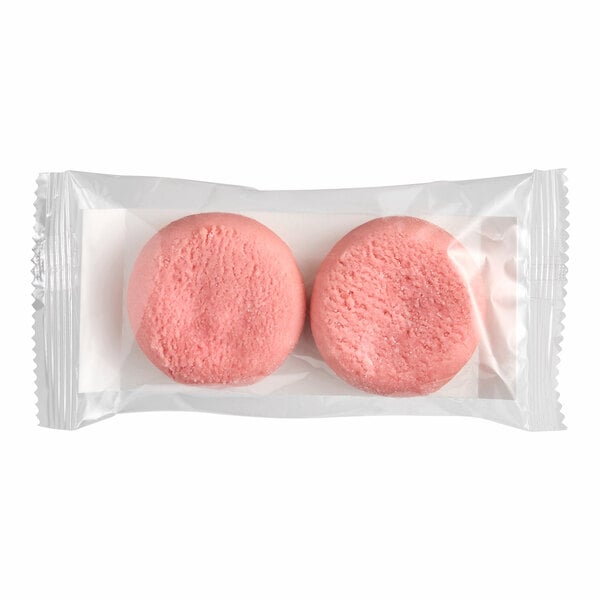 A package containing two pink vegan strawberry amaretti cookies.