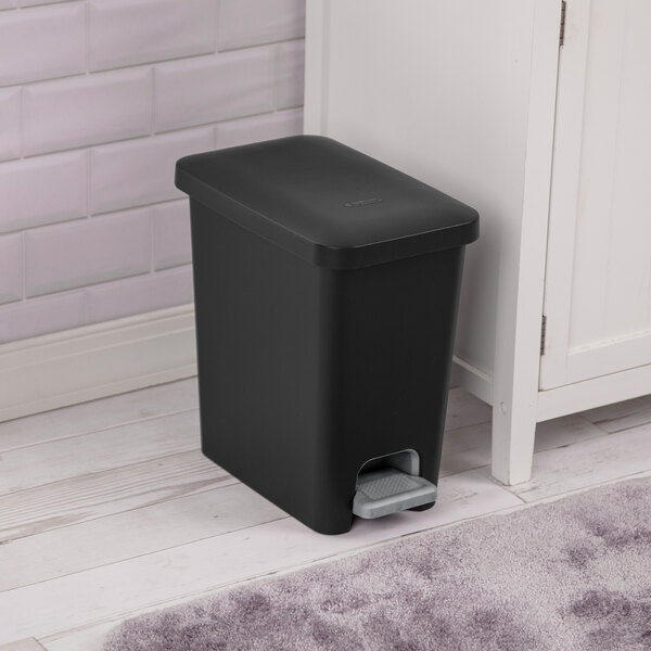 A black rectangular step-on wastebasket with a foot pedal.