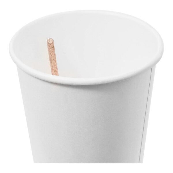A plain white paper cup containing a single natural agave stirrer straw.