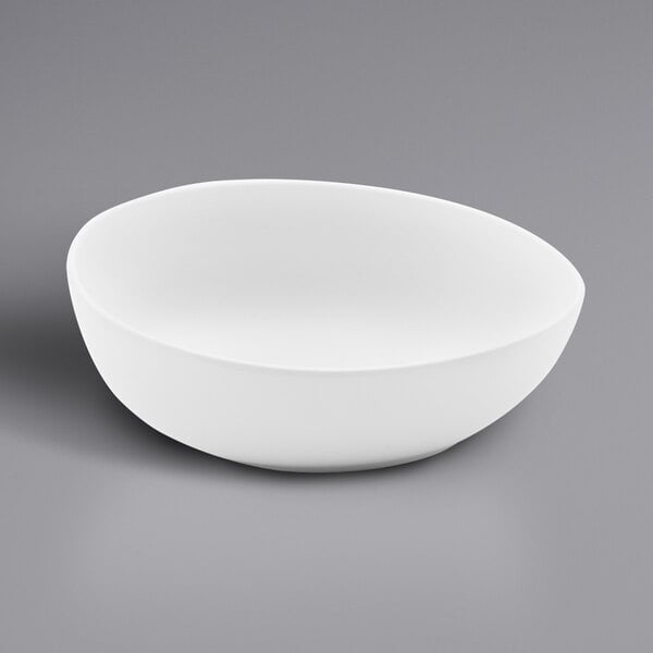 A white, irregular round matte melamine serving bowl with a 20 oz. capacity.