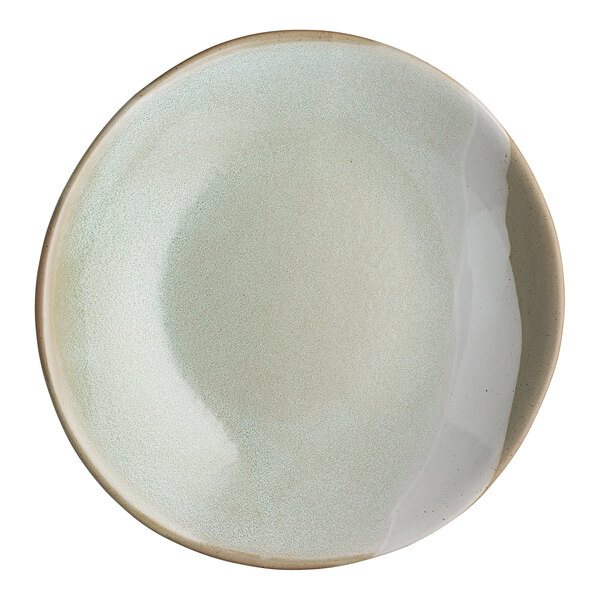 A round, light-colored stoneware bowl with a slightly irregular rim and a subtle gradient glaze.