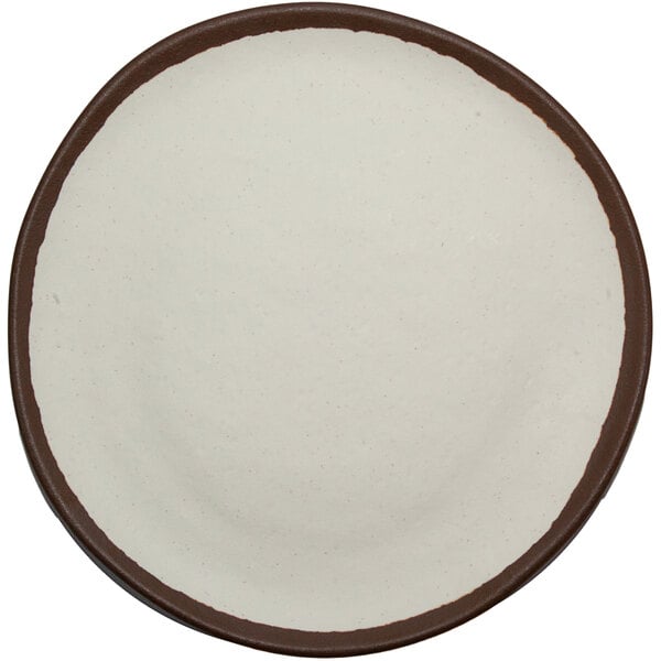 A cream-colored ceramic coupe plate with a brown trim.