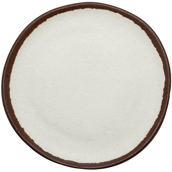 A small cream-colored coupe plate with a brown trim.