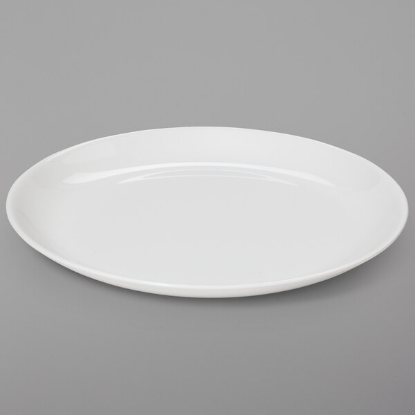 A plain, round, ivory-colored melamine dinner plate.