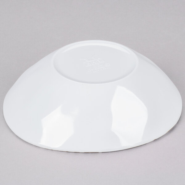 A white, irregularly shaped melamine bowl shown upside down.