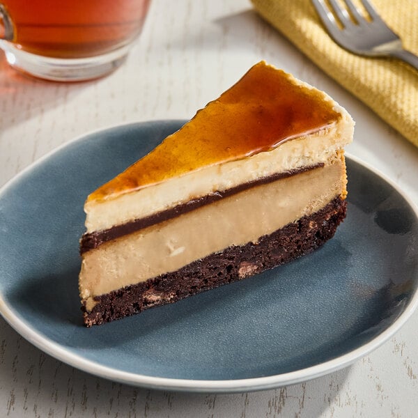 A slice of layered Irish coffee cheesecake with a caramelized top, served on a blue plate.