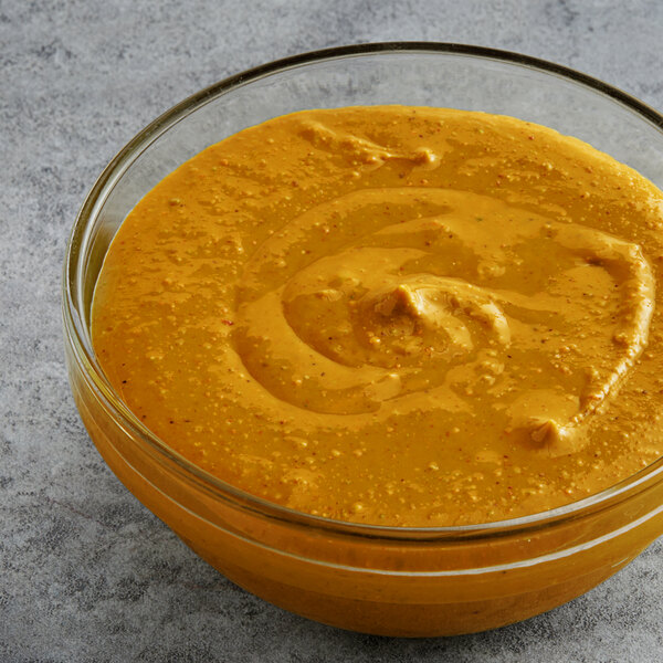 A glass bowl filled with unsalted pistachio butter.