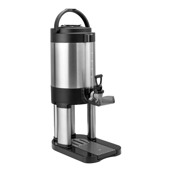 A brushed stainless steel thermal coffee server with a stand and handle.