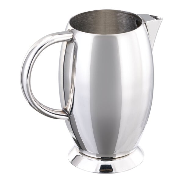A polished stainless steel creamer with a handle and spout.
