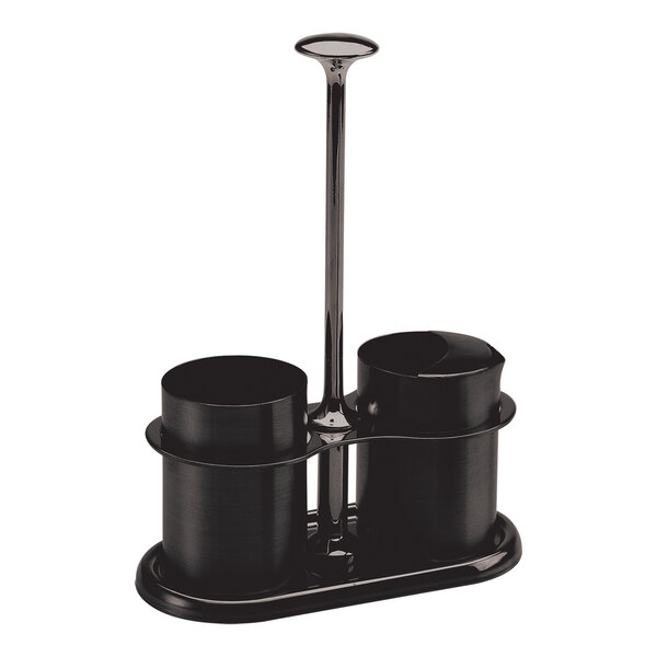 A black onyx stainless steel sugar stick holder and creamer set with two cylindrical containers on a tray.