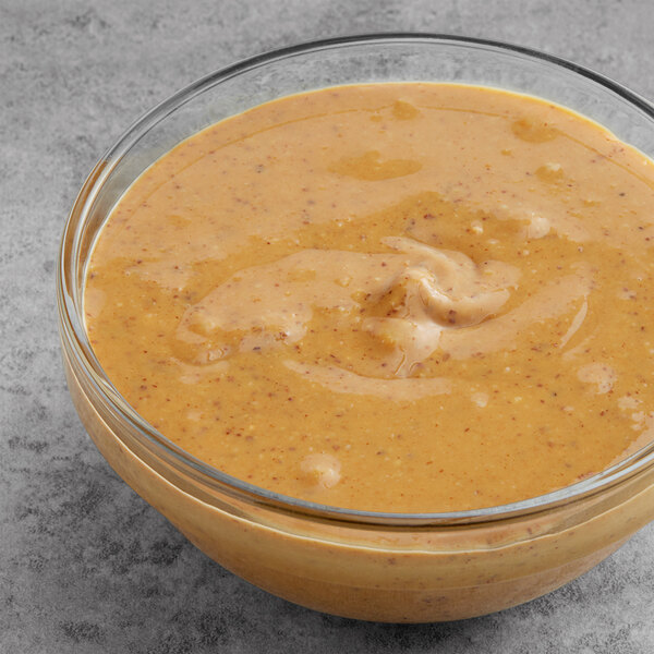 A glass bowl filled with salted almond butter.