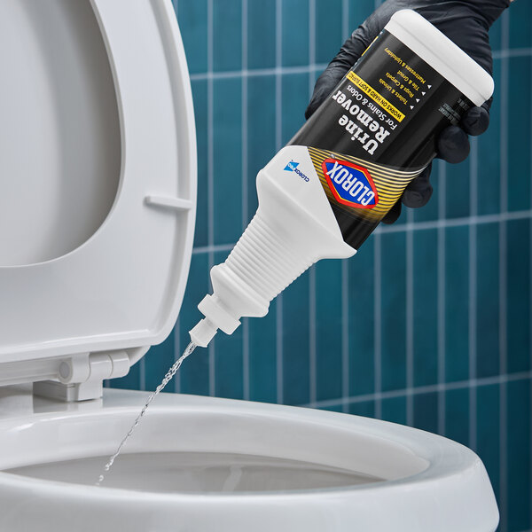 A bottle of CloroxPro Clorox urine stain and odor remover being poured into a toilet.