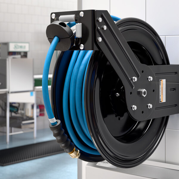 A black powder-coated steel hose reel mounted on a wall, holding a coiled blue 100-foot air or water hose.