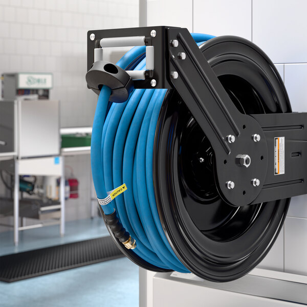 A wall-mounted powder-coated steel hose reel with a coiled blue air or water hose.