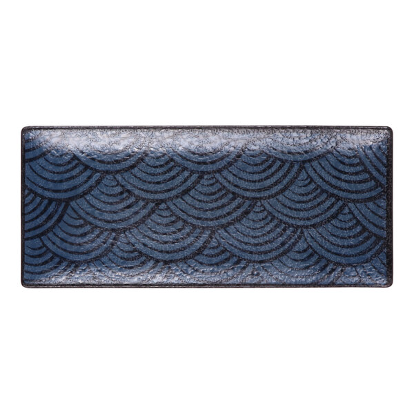 A rectangular dark blue melamine platter with a scalloped pattern.