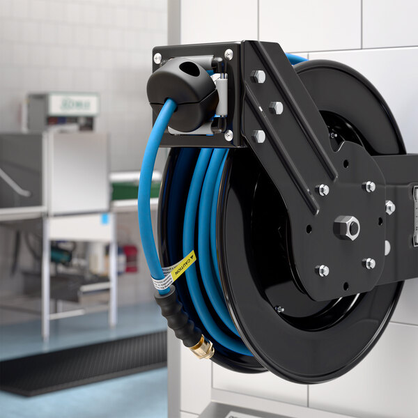 A black powder-coated steel hose reel with a blue 30-foot air or water hose mounted on a wall.