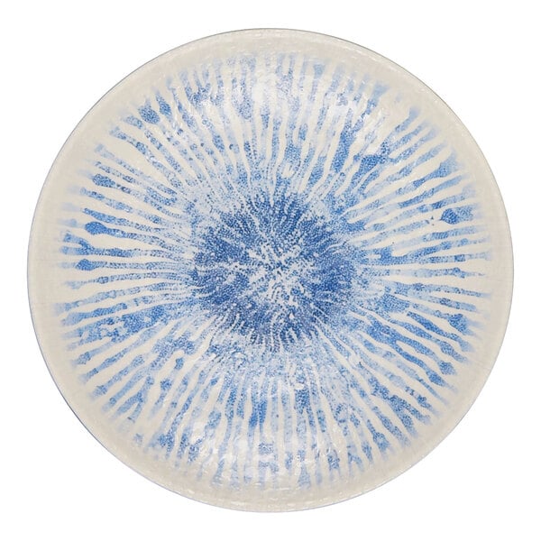 A round light blue melamine plate with a radiating white and blue pattern.