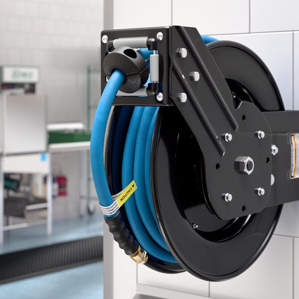 A powder-coated steel hose reel with a 30-foot blue air or water hose mounted on a wall.