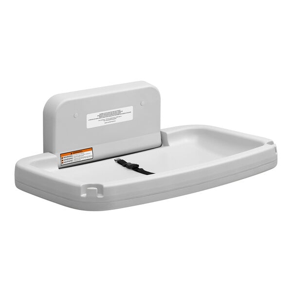 A gray horizontal surface-mounted baby changing station with a safety strap.