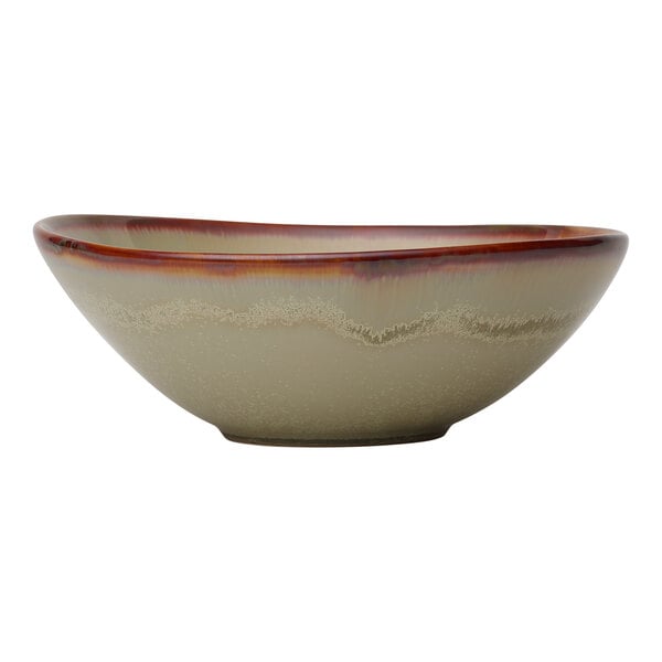 A large sage-colored porcelain bowl with a decorative rim.