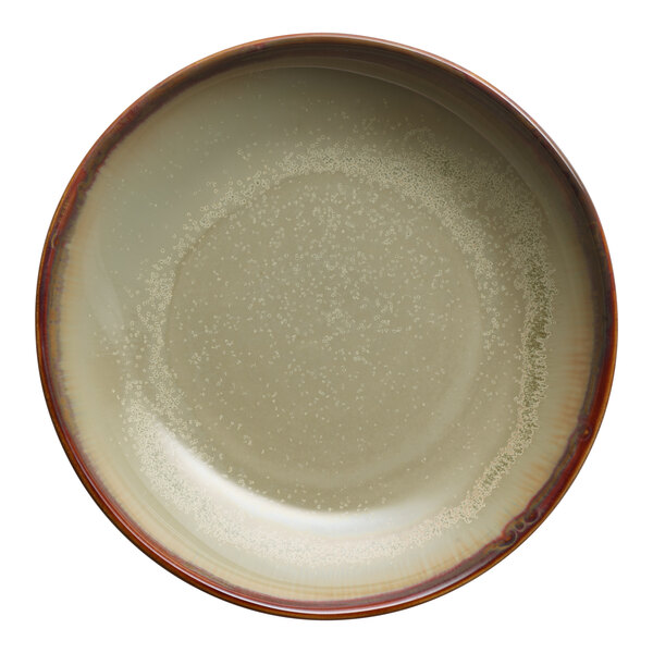 A round porcelain coupe bowl with a sage green interior and a brown rim.