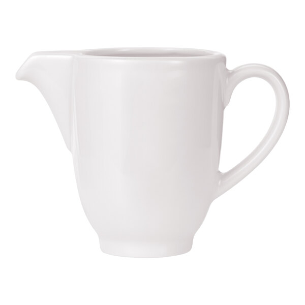 A white porcelain creamer with a handle and spout.