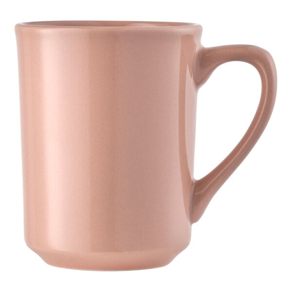 A coral-colored porcelain mug with a handle.