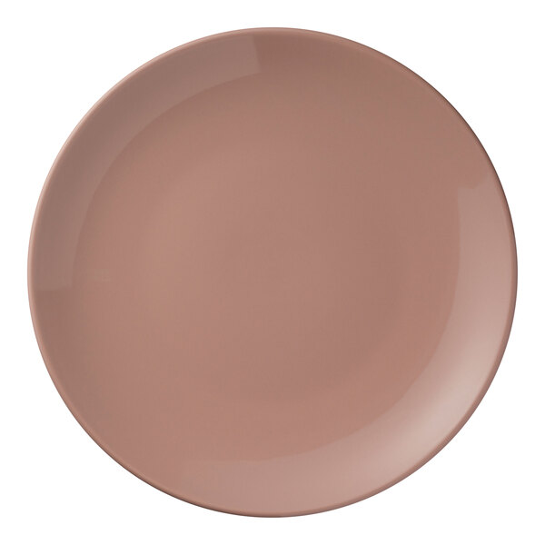 A round, coral-colored porcelain coupe plate.