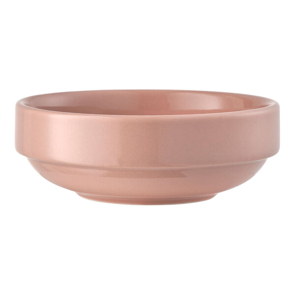 A round, coral-colored porcelain bowl with a stackable design.