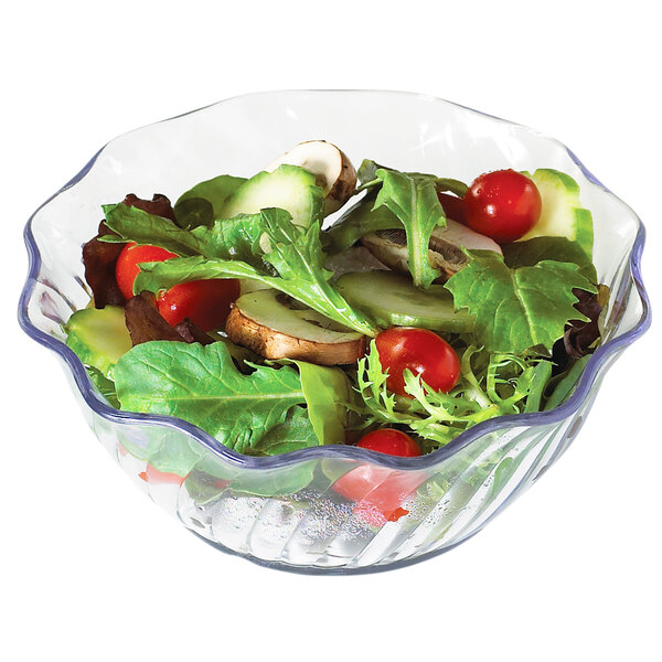 A clear Cambro swirl bowl filled with salad with vegetables.