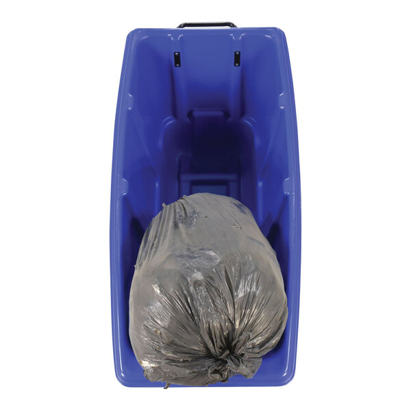 A blue medium-duty bulk tilt truck containing a tied black trash bag.