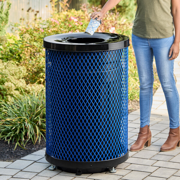 A large blue round outdoor trash can with a flat black lid, designed for heavy-duty use.