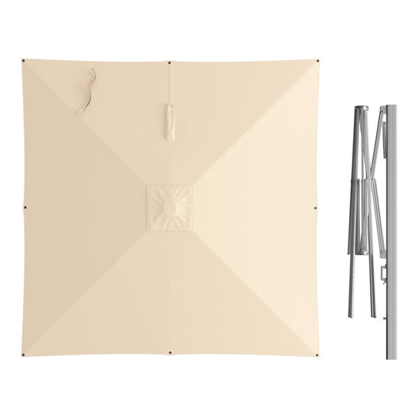A large square sand-colored cantilever umbrella with a silver aluminum hydraulic lift frame.