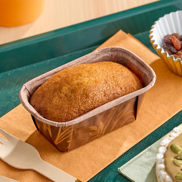 A small rectangular vegan banana pound cake in a brown paper baking tray.