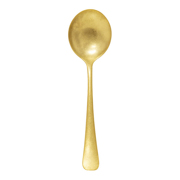 A gold-colored stainless steel soup spoon with a vintage finish.