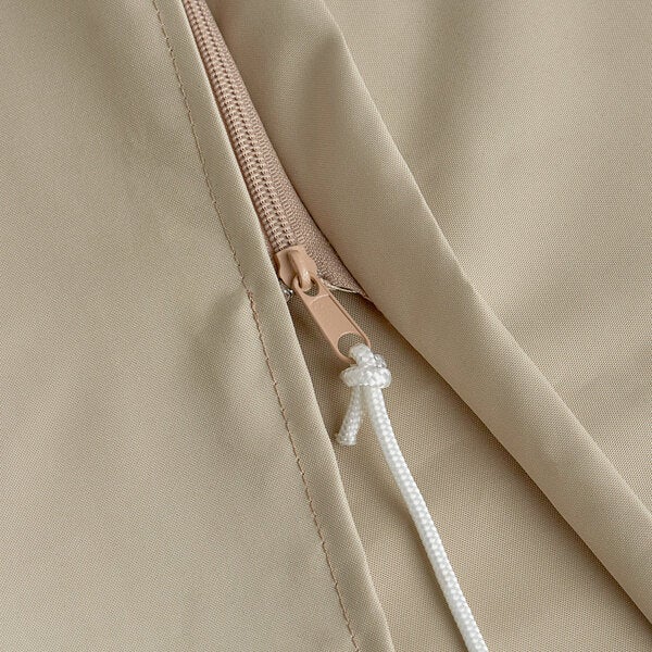 A beige polyester umbrella cover with a zipper and a white pull cord.