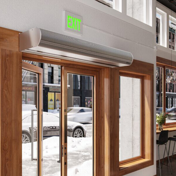 An ambient air curtain mounted above a glass entry door in a commercial setting.